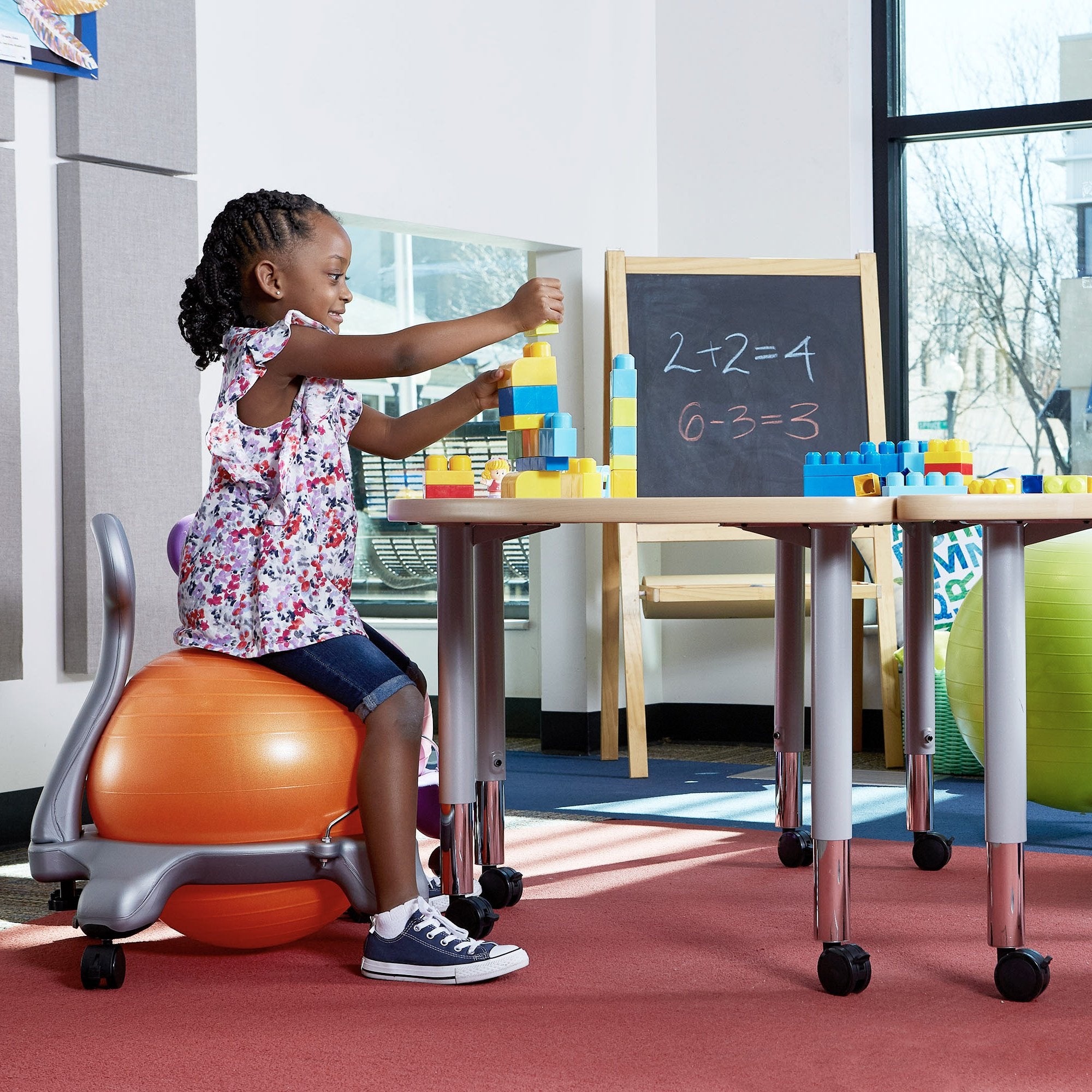 Sitting on the Kids Classic Balance Ball Chair in class